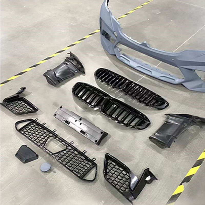 G20 M3-style bumper parts arranged on warehouse floor